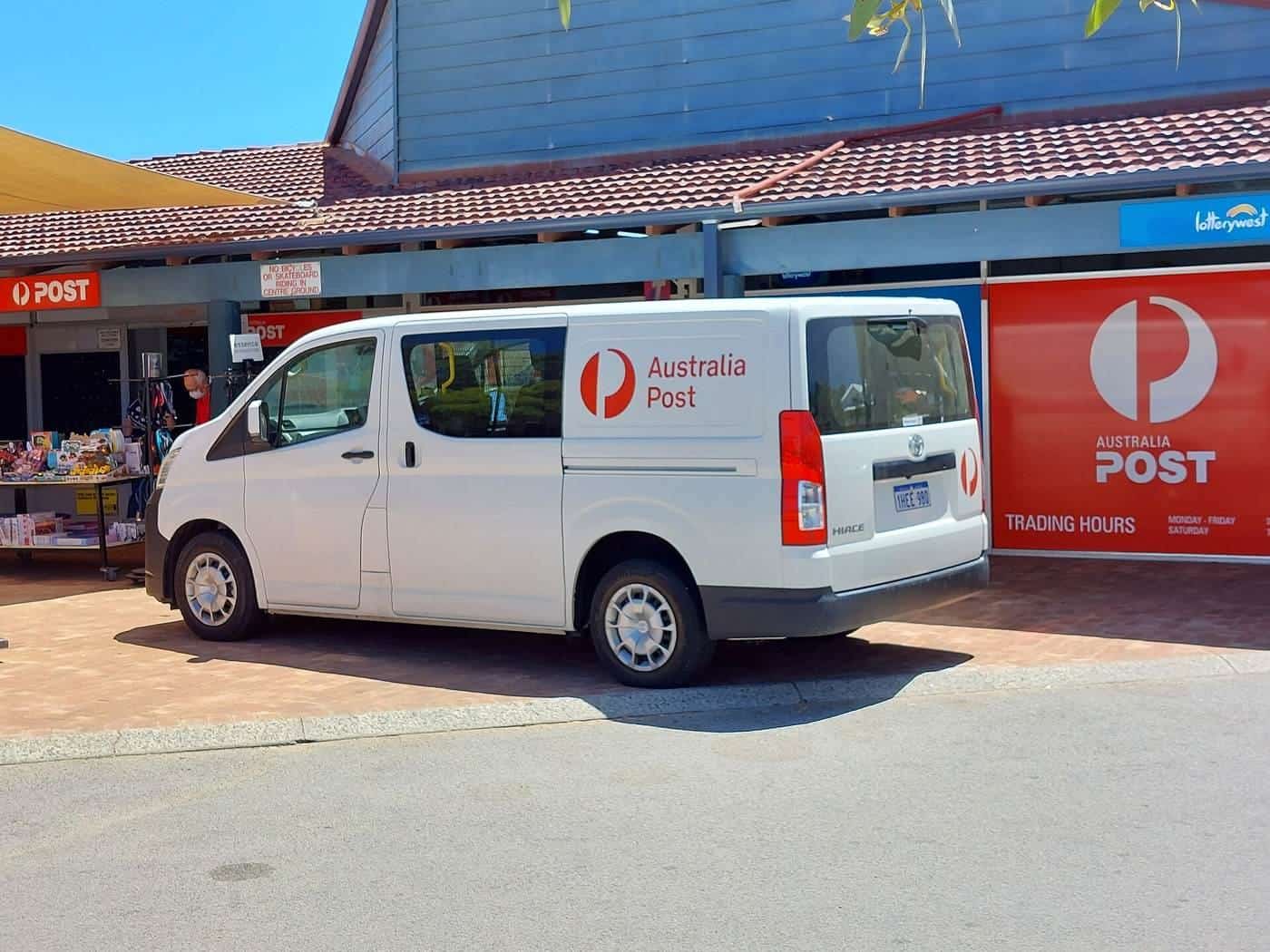 A white Australia Post delivery van parked outside a suburban post office in Western Australia