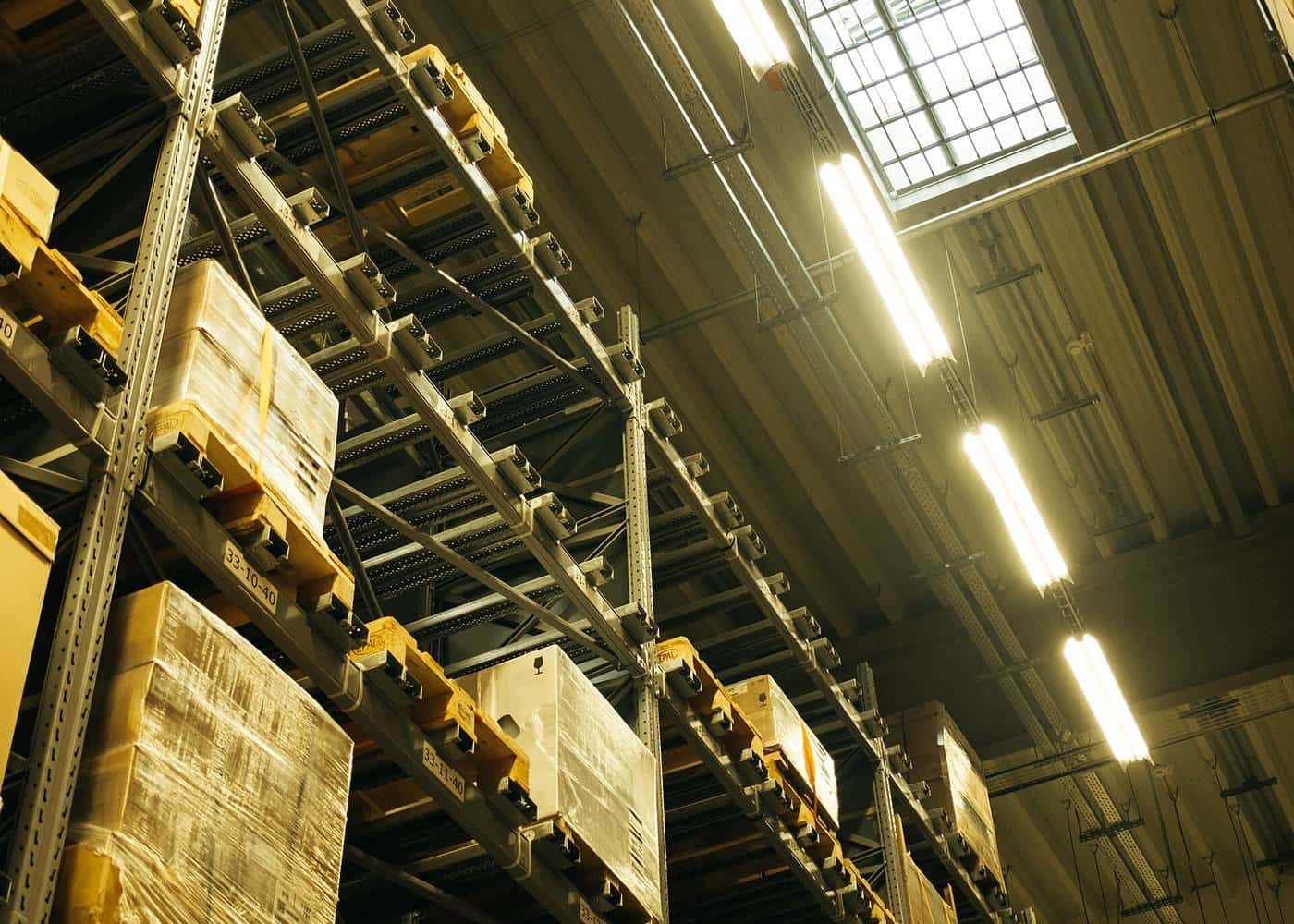 Tall warehouse shelving stacked with labelled boxes